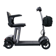 Black mobility scooter with a seat and bag on a white background