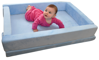 Baby lying on a blue and white playpen