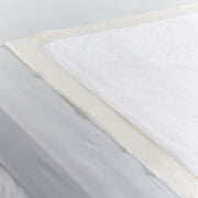 Close-up of a fabric swatch with white, beige, and gray colors.
