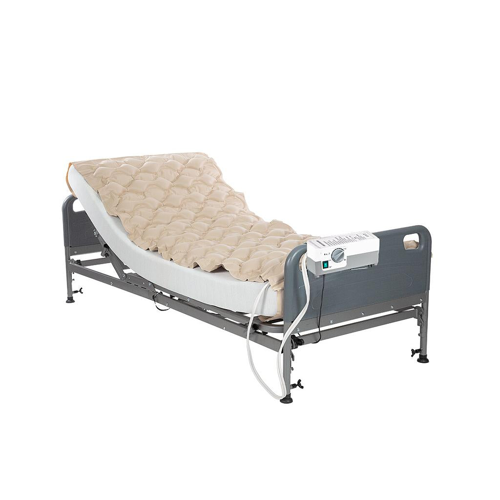 Electric hospital bed with beige mattress on a white background