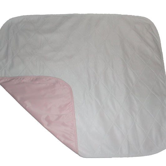 Gray quilt with a pink corner on a white background