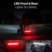 A motorized scooter shown at night on a residential street, with large text reading 'LED Front & Rear Lights for Safety' and two smaller inset views showing the bright red rear light and the white front light.