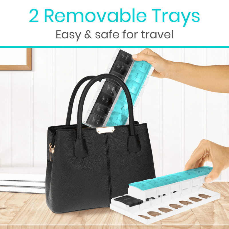 Black handbag with 2 removable trays for travel, held by a hand.