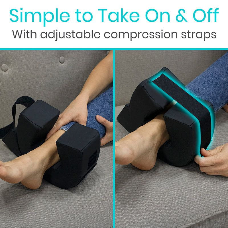 Person using black compression leg sleeves with adjustable straps on a gray couch.