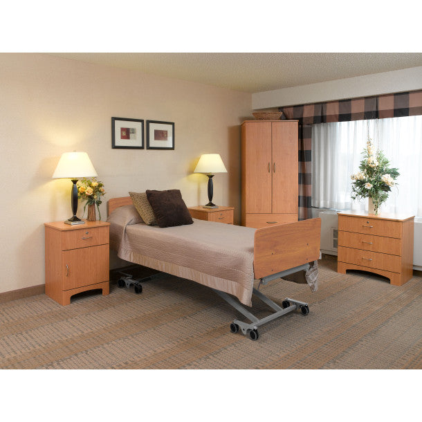 A calm, well-arranged bedroom with an adjustable care bed, a sturdy bedside nightstand, and a lamp