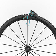 Close-up of a bicycle wheel with Refire branding on a white background