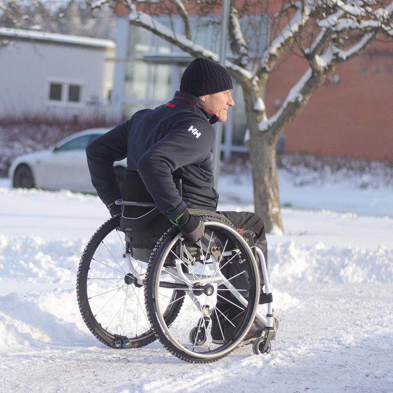 Person in a wheelchair navigating snowy terrain