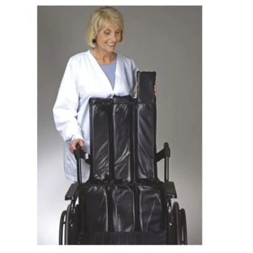 Person in a white coat holding a black wheelchair cover against a gray background