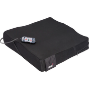 Black cushion with a remote control on a white background