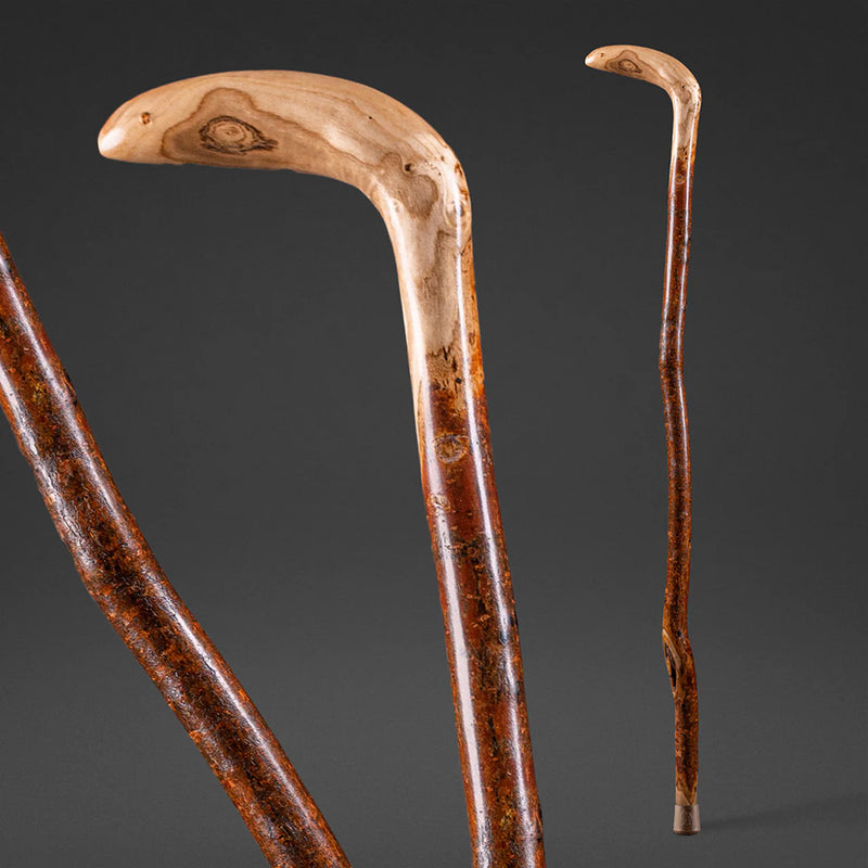 Two wooden walking canes on a dark gray background