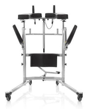 A silver metal and black padded medical walker with wheels, dual armrests, and a central support frame, shown on a white background with a faint reflection.