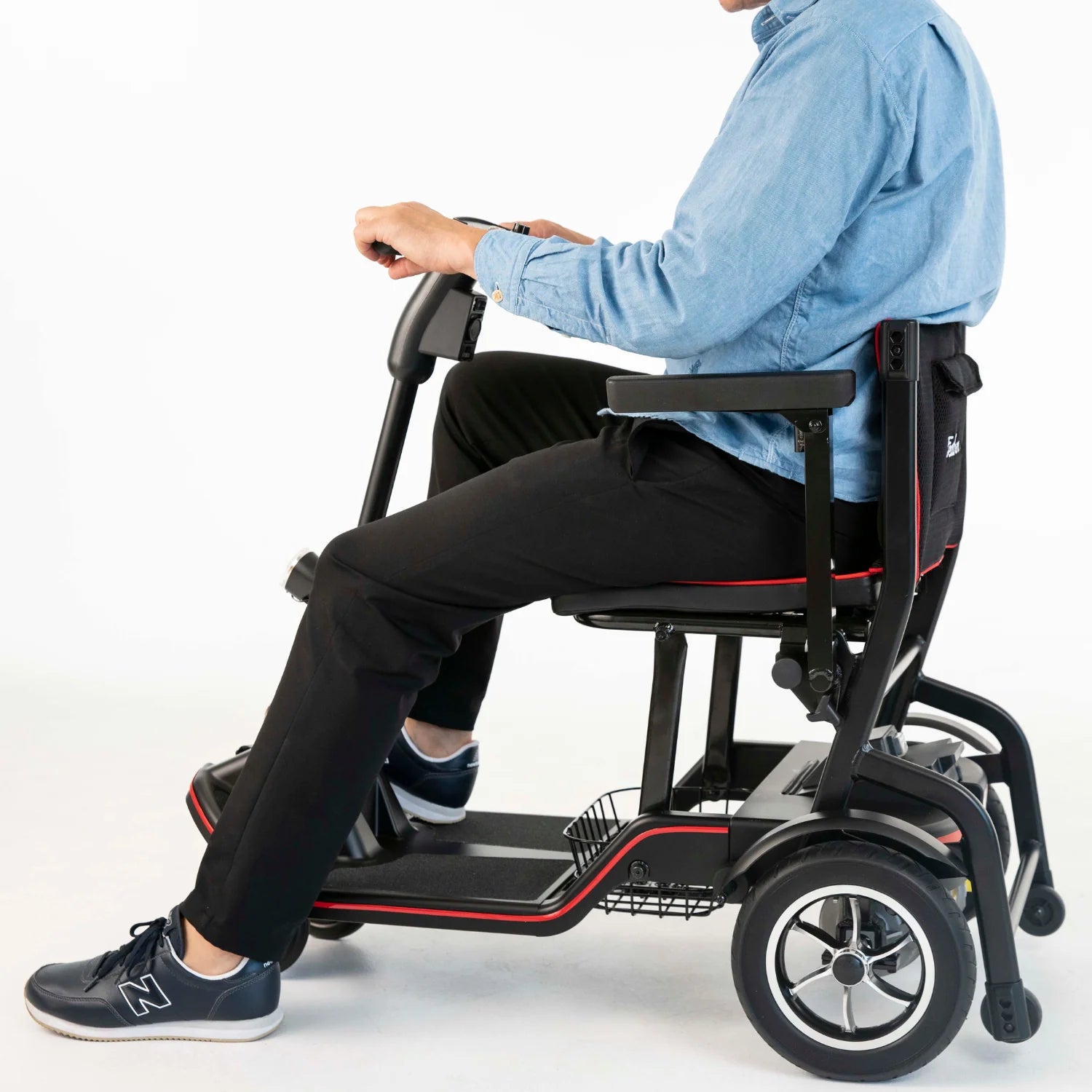Person using a mobility scooter on a white background