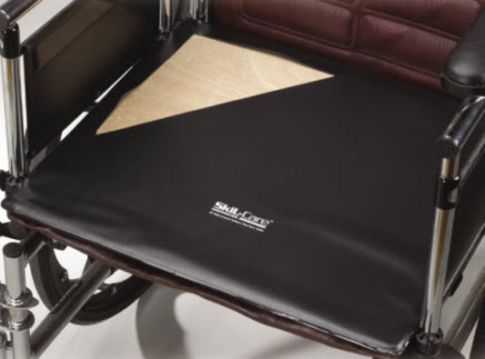 Black wheelchair cushion with 'SKIL-CARE' branding on a wheelchair.
