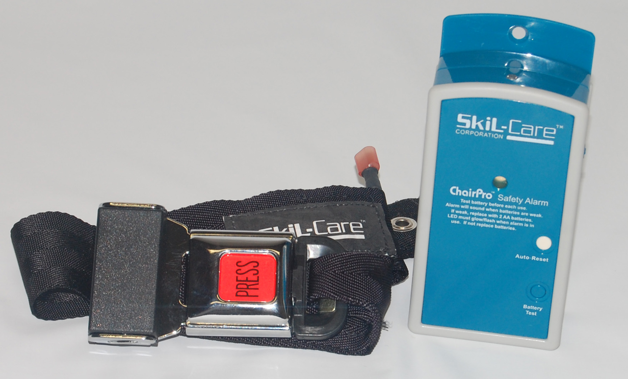Safety belt with a red button and Skil-Care chair pro safety alarm on a white background