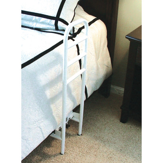 White metal bed frame against a beige wall with a window in the background