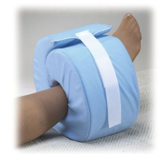 Blue leg elevation pillow with a white band on a person's leg against a neutral background