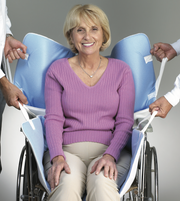 Woman in a wheelchair with a butterfly canopy, smiling.