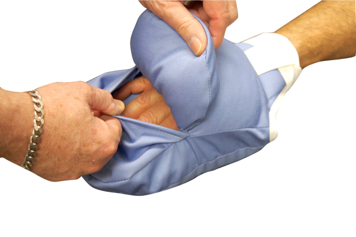 Person wearing a blue cast with hands adjusting it on a white background