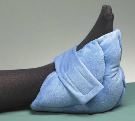 Blue foot pillow on a foot with a gray background