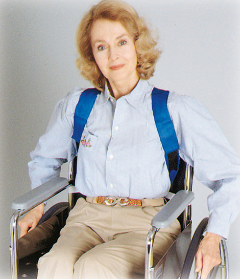 Person in a wheelchair with blue straps on a plain background