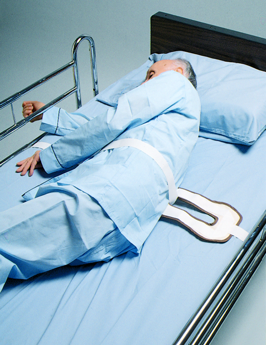 Person lying in a hospital bed with blue sheets and pillow