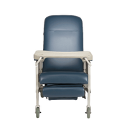 A blue upholstered medical-style chair with a light beige tray table and matching footrest, shown on a plain white background.
