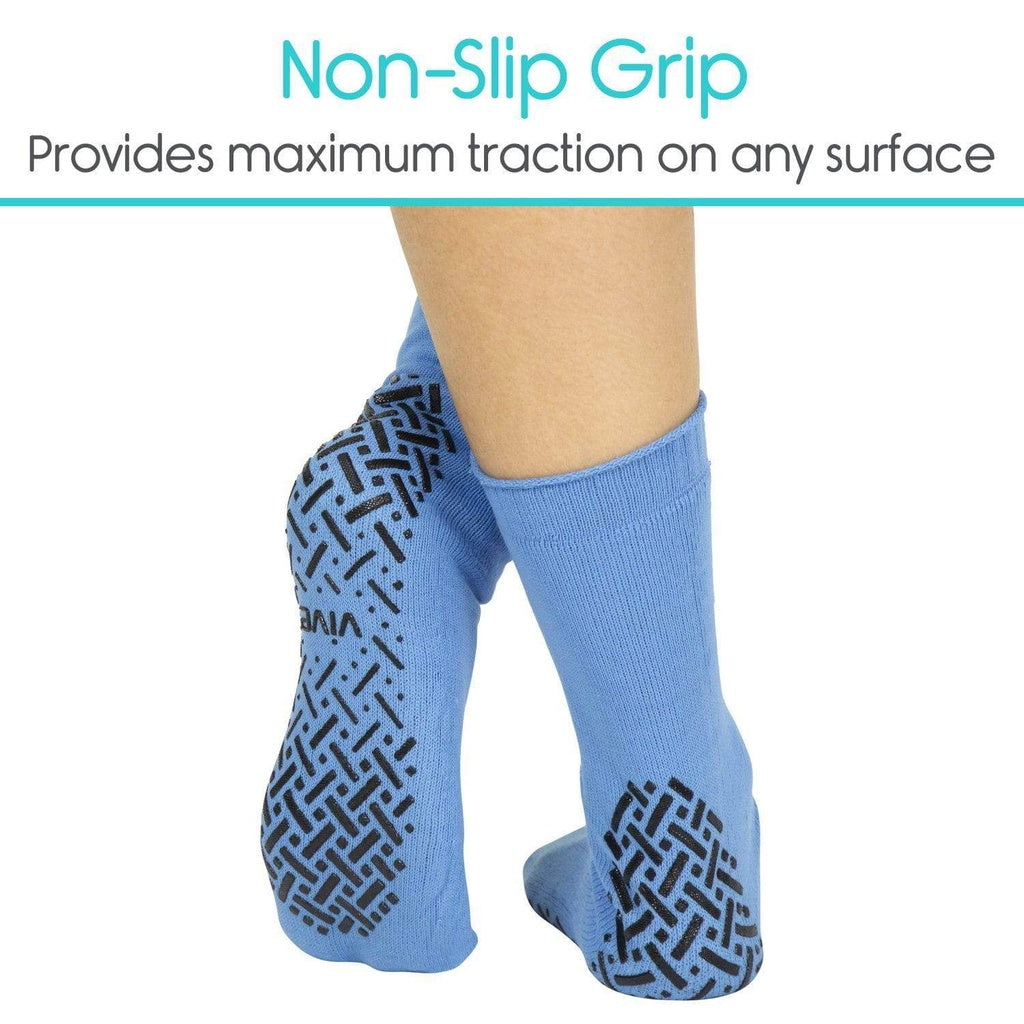 Blue socks with black textured sole on a white background, emphasizing non-slip grip.