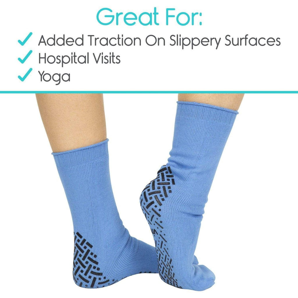 Blue socks with textured sole on a white background, labeled for added traction, hospital visits, and yoga.