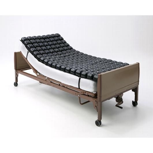Ergonomic bed with quilted foam surface on a white background