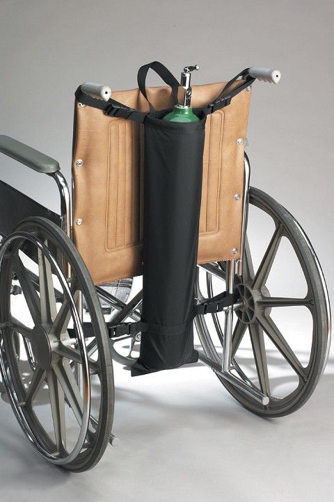 Wheelchair with a black oxygen tank holder attached to the backrest.