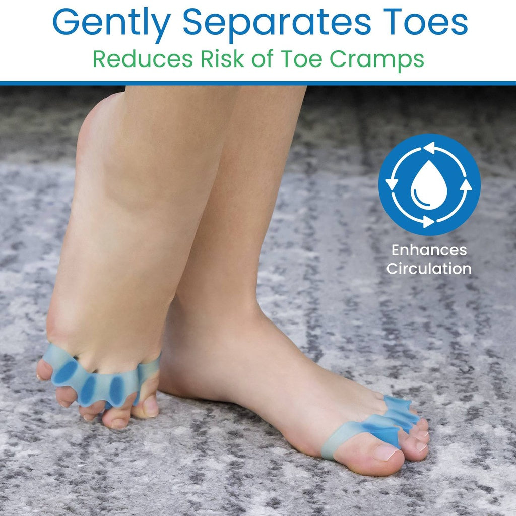 Bare feet with toe separators on a gray surface, promoting circulation and reducing toe cramps.