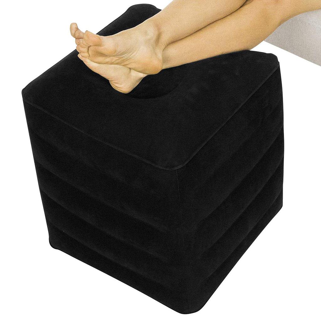Black footstool with a person's foot on top, on a white background