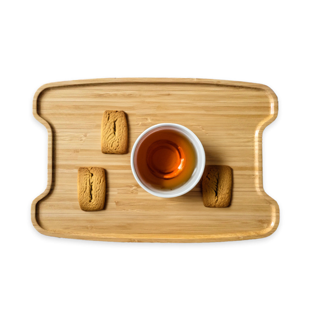 Wooden tray with a cup of tea and cookies on a white background