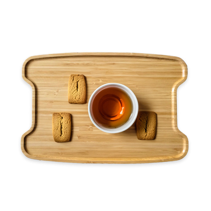Wooden tray with a cup of tea and cookies on a white background