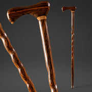 Three wooden walking sticks on a dark background