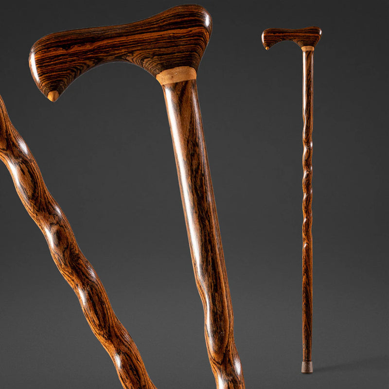 Three wooden walking sticks on a dark background