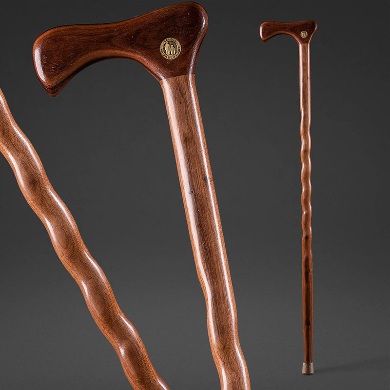 Two wooden walking canes on a dark gray background