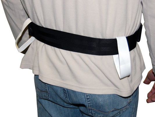 Person wearing a black belt with white buckles on a plain background