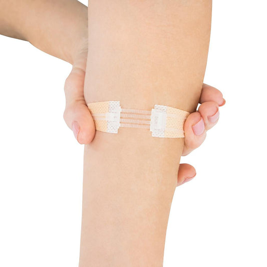 Person wearing a bandage on their knee against a white background
