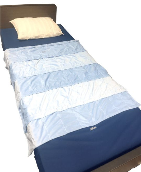 Blue and white quilt on a bed with a pillow