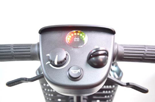 Close-up of a motorcycle handlebar with control panel and indicator lights on a white background