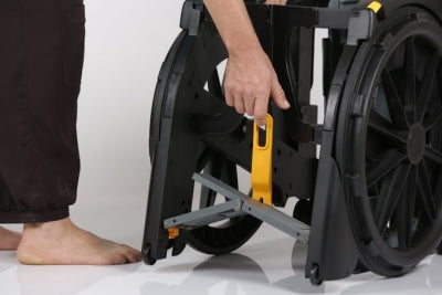 Person adjusting a wheelchair with a white background