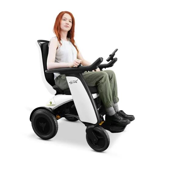 Person using a mobility scooter on a white background