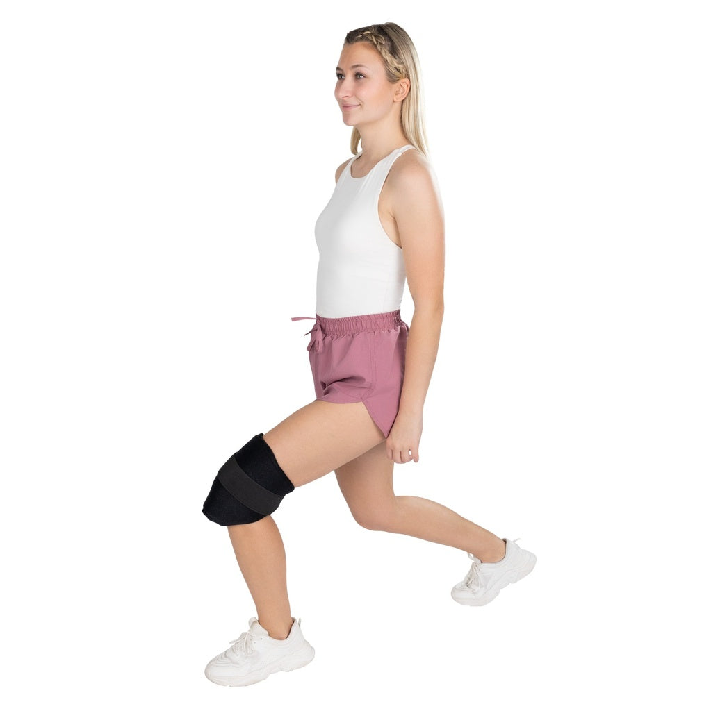 Woman wearing a black knee brace on a white background