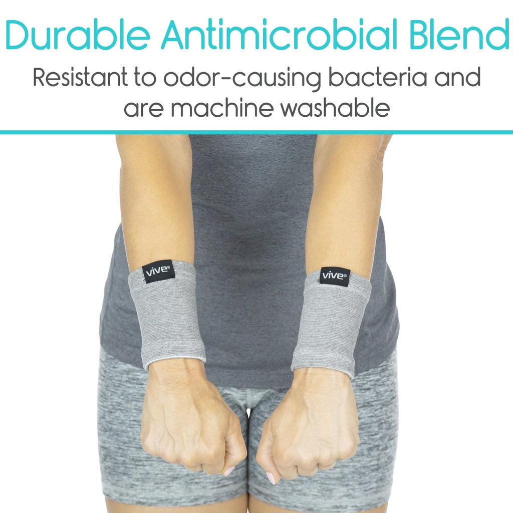 Gray wristbands with 'Vive' branding on a person wearing a gray outfit, with text about durability and antimicrobial properties.