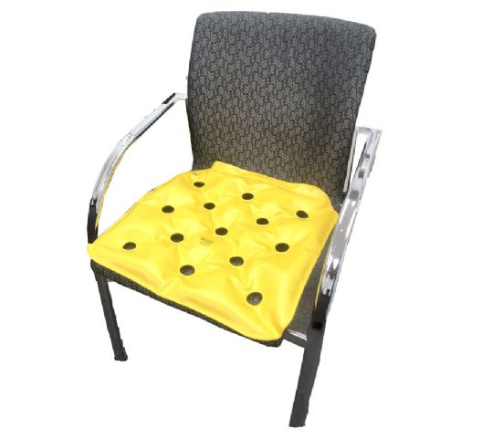 Chair with a yellow cushion featuring black holes on a white background
